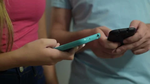 Close-up of two people using smart phone 스톡 동영상 55427717