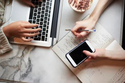 Close Up Of Two People Working Remotely In Cafe Stock Photos