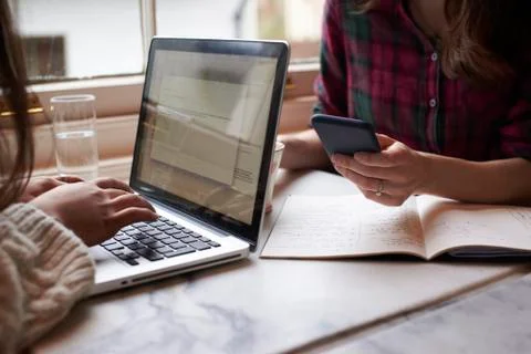 Close Up Of Two People Working Remotely In Cafe Stock Photos