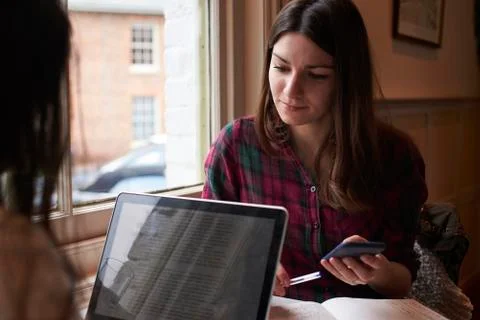 Close Up Of Two People Working Remotely In Cafe Stock Photos