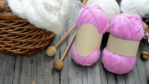 Close up two pink balls of wool threads on wood desk. Video stock 118254573