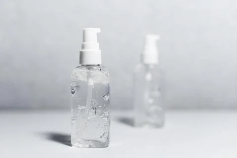 Close-up of two portable plastic bottles with sanitizer antiseptic gel. Stock Photos