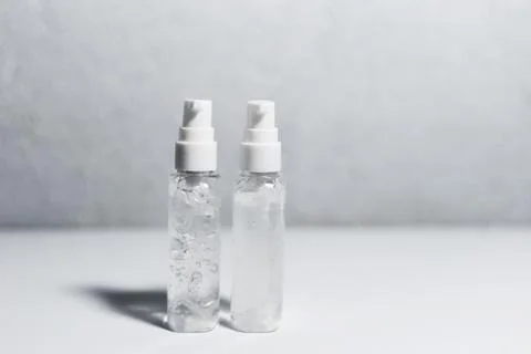 Close-up of two portable plastic bottles with sanitizer antiseptic gel. Stock Photos