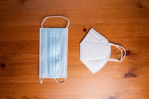 Close-up of two protective face masks, a surgical mask and a N95 Respirator Stock Photos
