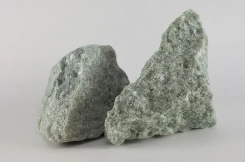 Close-up of two raw jade mineral stones, isolated on white background Stock Photos