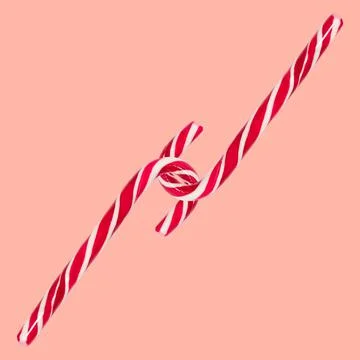 Close-up of two red candy canes isolated on background of pastel coral pink. Stock Photos