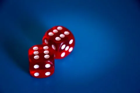 Close-up of two red dices with sixes on the top on a blue background Stock Photos