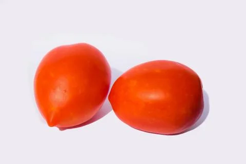 Close up of two red tomatoes isolated on white background. Stock Photos
