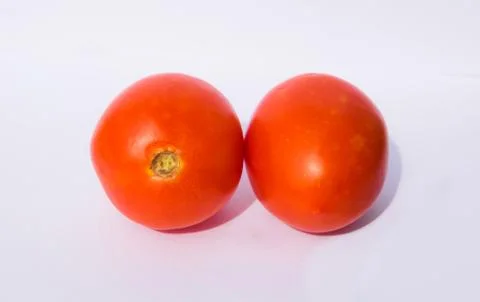 Close up of two red tomatoes isolated on white background. Stock Photos