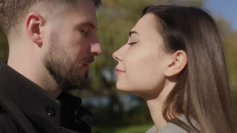 Close up of two romantic lovers touching foreheads in an outdoor cinematic vibe. Stock Footage 332763965
