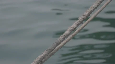 Close-up of two ropes connecting an old fishing boat to the Green Sea. Stock Footage 135452568