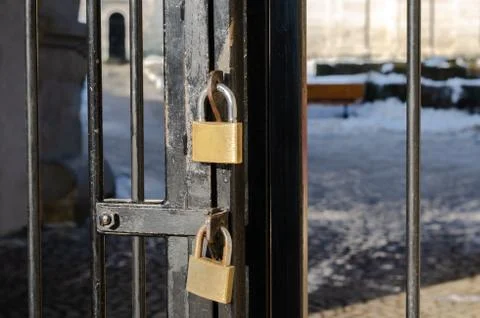 Close-up of two rusty locked padlock on metal door Stock Photos
