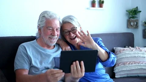 Close up of two seniors or old mature people doing a video call with friends or  Stock Footage 135683147