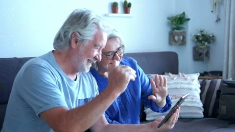 Close up of two seniors or old mature people doing a video call with friends or  動画素材 135683165