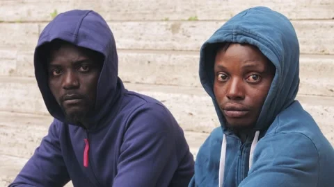 Close up on two serious young immigrants African staring at camera Stock Footage 218613773