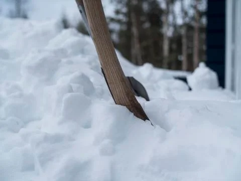 Close up of two showels placed in deep snow Stock Photos