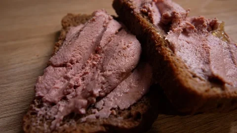 Close-up of two slices of dark rye bread generously Stock Footage 328580136
