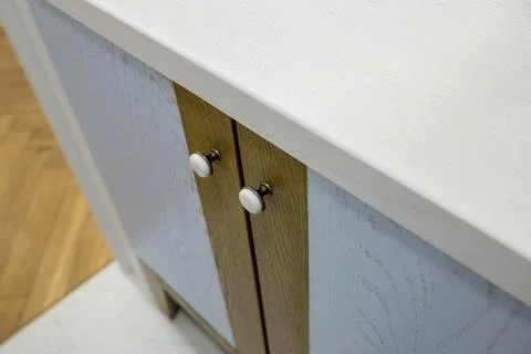 Close-up of two small round doorknobs on a bathroom cabinet Stock Photos