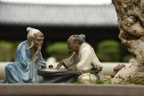 Close up of two small statues of chinese men inside Chi Lin nunnery in Hong Kong Stock Photos
