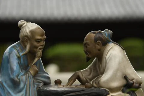 Close up of two small statues of chinese men inside Chi Lin nunnery in Hong Kong Stock Photos