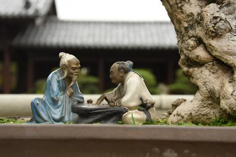 Close up of two small statues of chinese men inside Chi Lin nunnery in Hong Kong Stock Photos