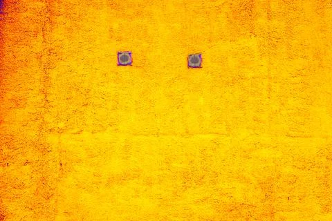 Close up of two small window with frame in the yellow wall. abstract grunge w Ilustración de archivo