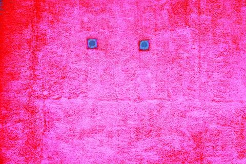 Close up of two small window with frame in the yellow wall. abstract pink bac Ilustración de archivo