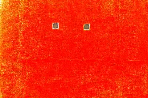 Close up of two small window with frame in the yellow wall. Red painted wall  Ilustración de archivo