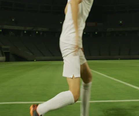 Close up of two soccer players practising on football stadium at night Stock Footage 147058175