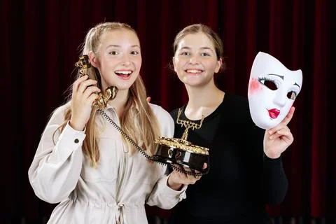 Close-up of two theatre actresses displaying strong emotions in their roles. Stock Photos
