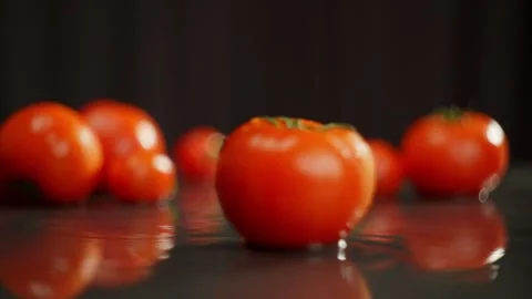 A close-up of two tomatoes falling in slow motion one after the other. Stock Footage 271264143
