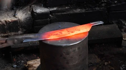 Close up of two vietnamese people pounding piece of hot metal with steel hammers Stock Footage 147370138