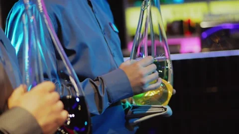 Close-up of two waiters holding decanters with red and white wine. Stock Footage 169209080