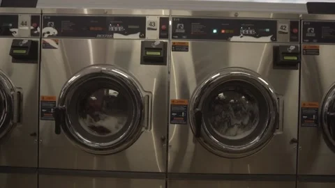 Close up on two washing machines in the process of working Stock Footage 157499249