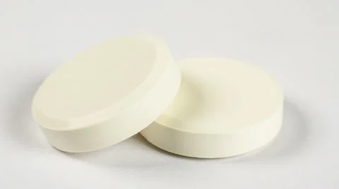 Close-up of two white pills on white background rotation Video stock 54687298