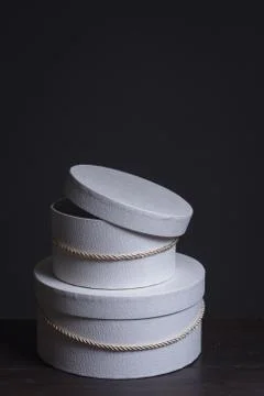 Close-up of two white round gift hat boxes on a dark background, selective fo Stock Photos