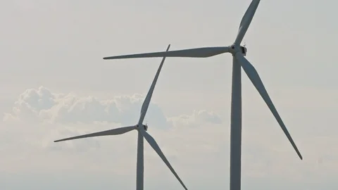 Close-up two wind turbines rotate against cloudy skies Stock-Footage 121301141
