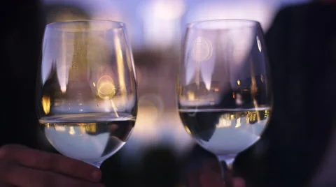Close up of two wine glasses being toasted at dusk Stock Footage 44178236