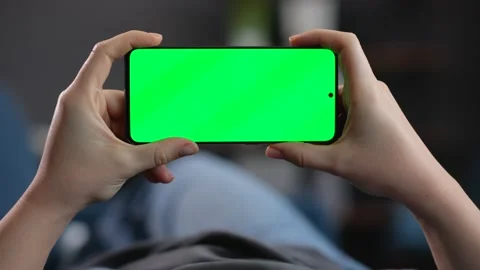 Close Up of two Woman`s Hands are holding Smartphone with Green Screen Mock-up Stock Footage 142077714