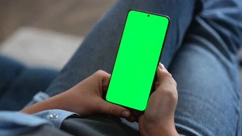Close Up of two Woman`s Hands are holding Smartphone with Green Screen Mock-up Видео 142079223