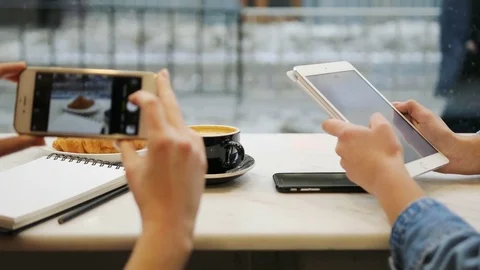 Close-up of two women hands taking photos of food and using tablet computer in Stock Footage 72361835