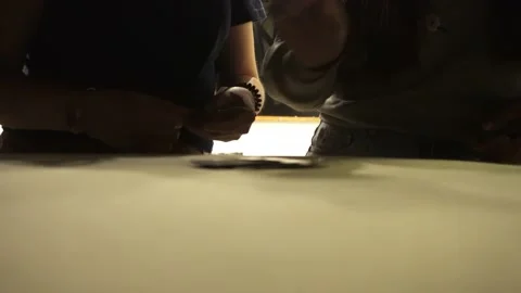 Close-up of two women playing a card game on top of a cushion and banging their 库存影片 178209348