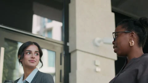 Close-up of Two Women Talking and Walking Down Modern Business Center Stock-Footage 302540472