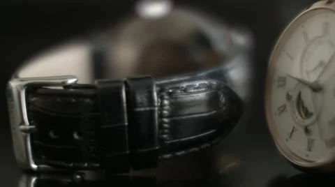 Close up of two Wrist Watches facing front and back against dark background Stock Footage 68194938