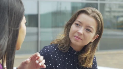 Close-up of two young adults having a conversation outside Video stock 132996846