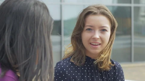Close-up of two young adults having a conversation outside Stock Footage 133651397