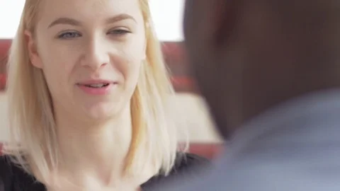 Close-up of two young colleagues discussing in the office Stock Footage 73858119
