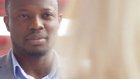 Close-up of two young colleagues discussing in the office Stock Footage 73859137
