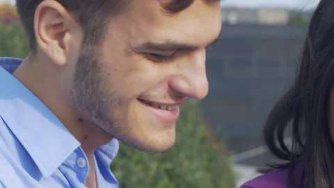 Close up of two young colleagues looking at tablet outdoors in the city Stock-Footage 133092362