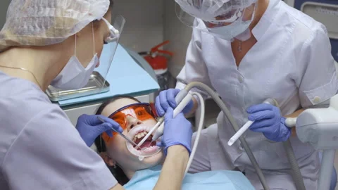 Close-Up Of Two Young Female Dentists With Glasses Working Stock Footage 138062014
